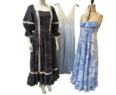 Mixed era vintage fashions to include a 1970s prairie dress with polka dot print, a 1970s nylon chiffon nightgown with ombre 