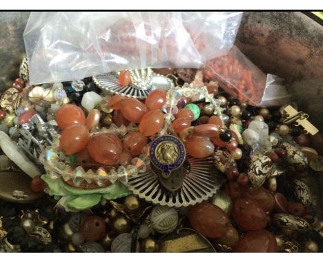 A vintage Symbol Biscuits tin containing a mixed lot of mostly damaged jewellery to include broken coral necklaces, agate bea