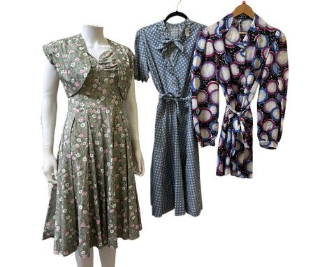A blue and white 1940s dress with spotty print, a 50s dress with unusual painterly landscape print in shades of grey, a 50s s