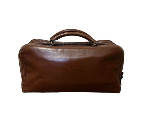 A rare mid century vintage Hermes travel bag in a mid tone brown leather  with two top handles and a brass Eclair zipper with leather pull (up until  the 90s Eclair zippers