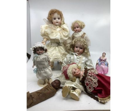 Antique doll heads and some are on replacement bodies to include a Marotte old bisque head redressed , a Native American Indi