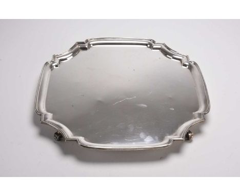 A large silver salver, Adie Brothers Ltd, Birmingham 1935, of shaped square form, raised on four scroll feet, 37cm wide, weig