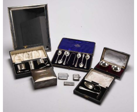 A collection of silver, comprising; a silver mounted mirror of rectangular form, a cased set of three silver cruets with two 