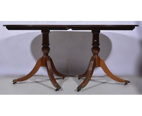 Reproduction mahogany twin pedestal dining table, rounded ends, stringing and crossbanding, fitted with a single leaf, balust