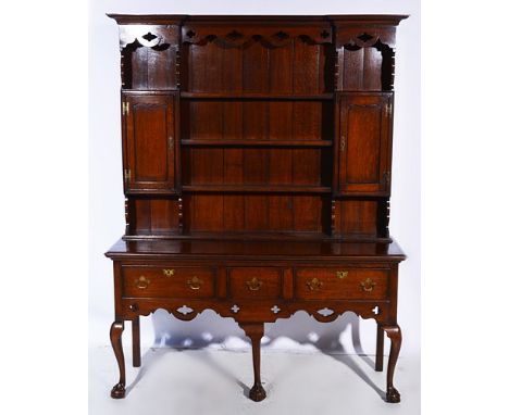 Reproduction oak dresser, three shelf delft rack incorporating cupboards, base with three drawers, cabriole legs, ball and cl