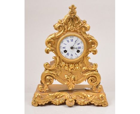 French gilt metal mantel clock, mid 19th Century, scrolled case, decorated with flowers, white enamel dial signed Henry, abbr