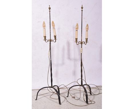 Pair of wrought iron adjustable standard lamps, each with twin candle fitments, tripod bases, urn finials, 132cm.