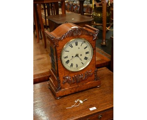 William IV rosewood mantel clock, scrolled outline, cream coloured dial, fusee movement, striking on a bell, 46cm.