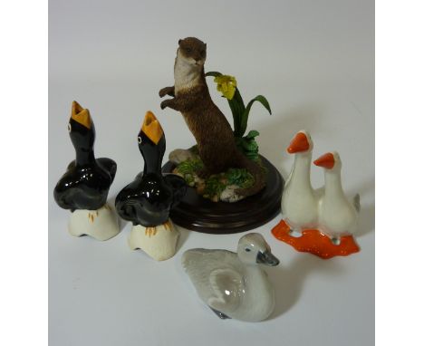 Royal Doulton otter sculpture H12.5cm, Royal Copenhagen cygnet, and Midwinter blackbird pie funnel, one other pie funnel and 