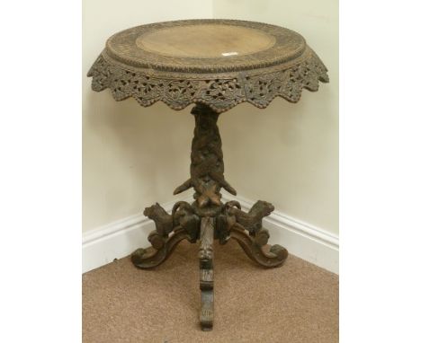 Early 20th century Burmese heavily carved rosewood tilt top table, ornate pierced flower and animal carvings on tripod base, 