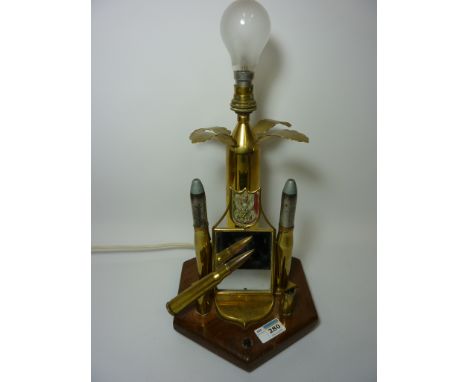 Trench Art lamp constructed of shell and bullet cases etc on wood plinth H33cm 
