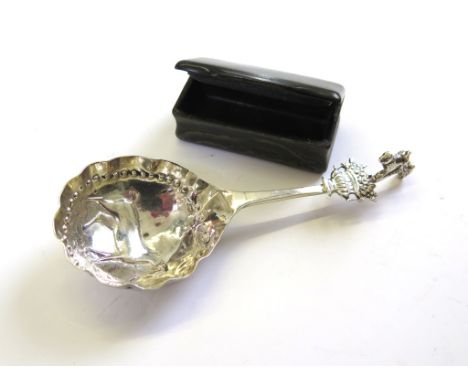 A white metal spoon and a horn snuff box