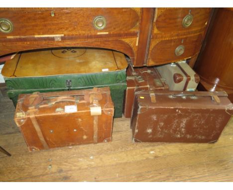 A leather suitcase, 57cm wide, a tin trunk and four other suitcases