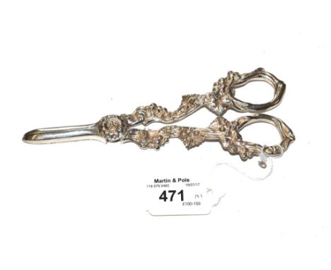 A cast pair of silver grape scissors decorated in vines, Birmingham 1988 together with a silver handled corkscrew (2)