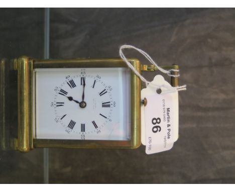 A small brass carriage clock with repeater movement (needs attention, strike arm bent) white enamel dial with Roman numerals,