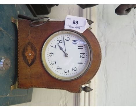 An Edwardian mahogany inlaid table time piece, of arched form with acorn finials, enamel dial and brass bracket feet, single 