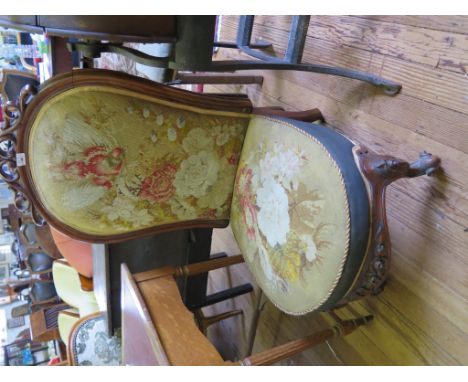 A Victorian walnut nursing chair with scroll carved top rail, original bird and floral tapestry upholstery and carved cabriol