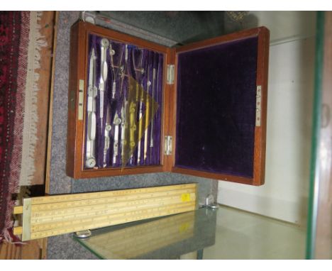 An Edwardian ivory slide rule by Dring & Page 19 & 20 Tooley Street, London, and a rosewood cased geometry set