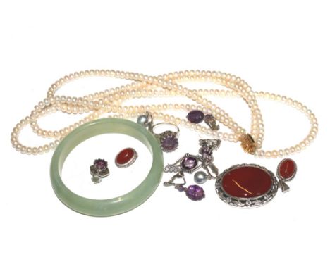 A selection of jewellery to include a jade bangle, a three row set of pearls, etc