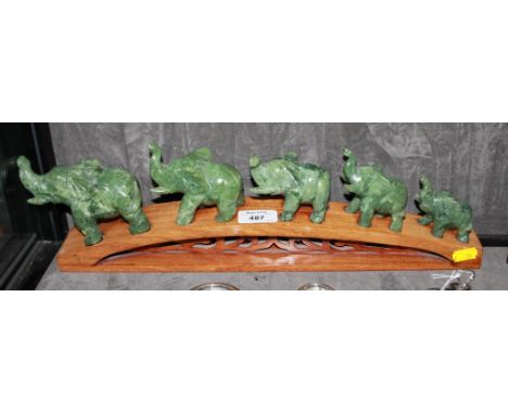 A jade figure group of a five elephant family on a bridge