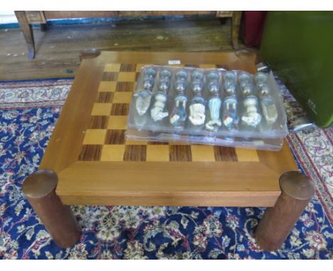 A teak backgammon and chess table with resin Napoleonic chess pieces, 60cm square x 26cm high