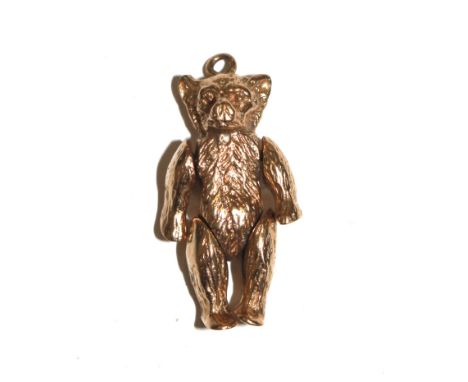 A gold colour articulated teddy bear