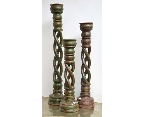 A GROUP OF THREE INDIAN MULTI-TWIST CANDLESTICKS
each on a circular base, with a multi twist standards supporting a shallow b