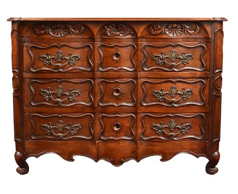 A LOUIS XV WALNUT COMMODE
rectangular, with three serpentine fronted drawers with carved panels and foliate cast metal handle