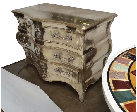 A LOUIS XV STYLE SILVER FOIL OVERLAID COMMODE
with a serpentine top above a bombe base with three full length drawers, cabrio