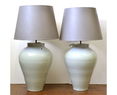 A SUBSTANTIAL PAIR OF BLANC DE CHINE GLAZED EARTHENWARE LAMP BASES

baluster, each with a cloth shade, each base 61cm high

