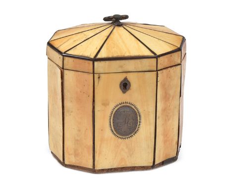 A DECAHEDRON IVORY VENEER AND BRASS TEA CADDY the panelled body articulated with brass, with a brass plate engraved 'M' withi