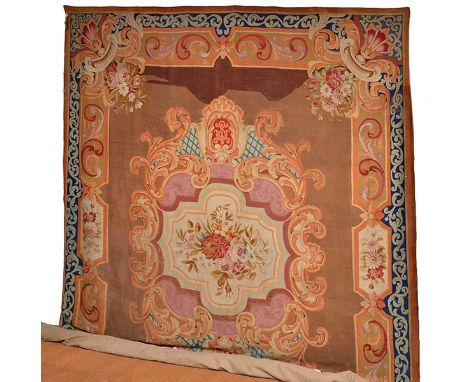 A FRENCH AUBUSSON WALL TAPESTRY, 18TH CENTURY
in muted tones, the shaped central cartouche with a floral bouquet motif within