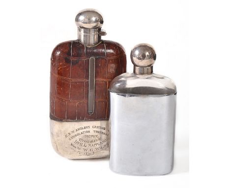 TWO SILVER PLATE MOUNTED HIP FLASKS
one of Sheffield plate with a crocodile skin bound flask with silver plated cap and inscr