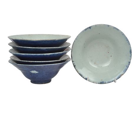 A GROUP OF SIX CERAMIC BOWLS

overglazed to the exterior in blue, with an abstract fan-like motif, naturally varying sizes be
