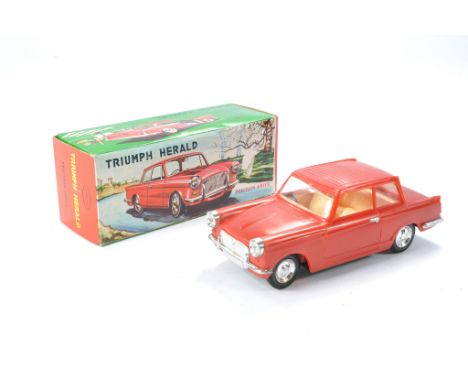 Jimson Plastic Mechanical Friction Driven Triumph Herald in Red. Light Peach interior, clear windows and chrome trim. Good wo