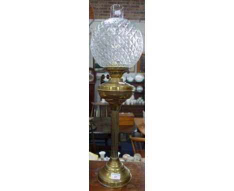 A BRASS OIL LAMP with clear mottled glass shade