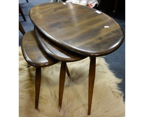 ERCOL: A nest of dark elm and beech pebble tables, the largest 65cm wide