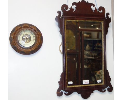 A GEORGE III STYLE MAHOGANY WALL MIRROR and an aneroid barometer