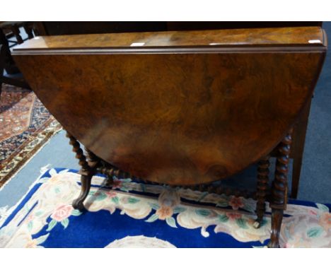 A VICTORIAN BURR WALNUT OVAL SUTHERLAND TABLE on barley twist and bobbin turned supports, stamped 'John Taylor &amp; Son Manu