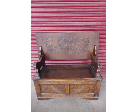 A 17th Century style carved oak monk's bench 