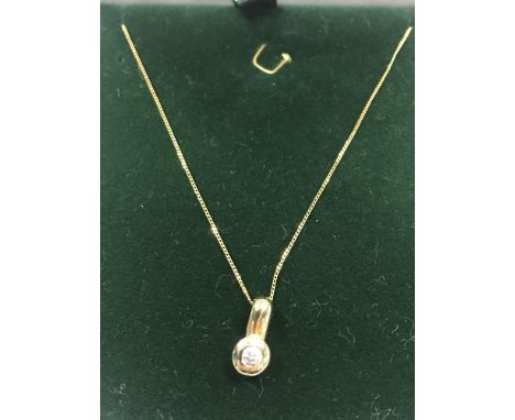 EIGHTEEN CARAT GOLD DIAMOND PENDANT set with a round brilliant cut stone of approximately 0.10 carats, on a nine carat gold c