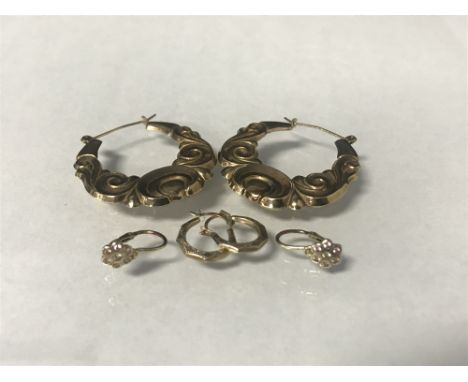 PAIR OF GOLD HOOP EARRINGS with swirl pattern decoration, approx 2.67g; along with two other pairs of earrings (3)