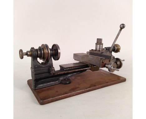 An early 20th Century clock makers lathe on oak base