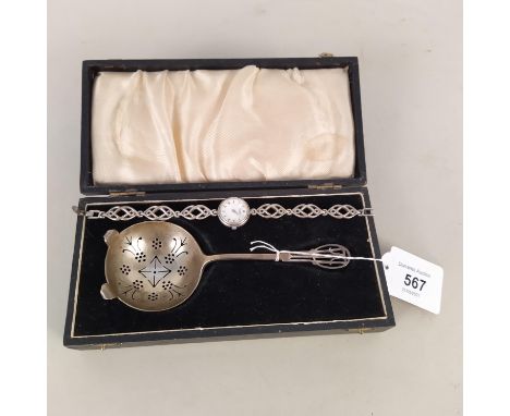 A boxed silver tea strainer, hallmarked Birmingham 1917, maker's mark rubbed, together with a lady's rotary watch