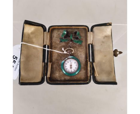 A continental white metal fob watch with green enamel decoration suspended from white metal bow brooch with enamel decoration