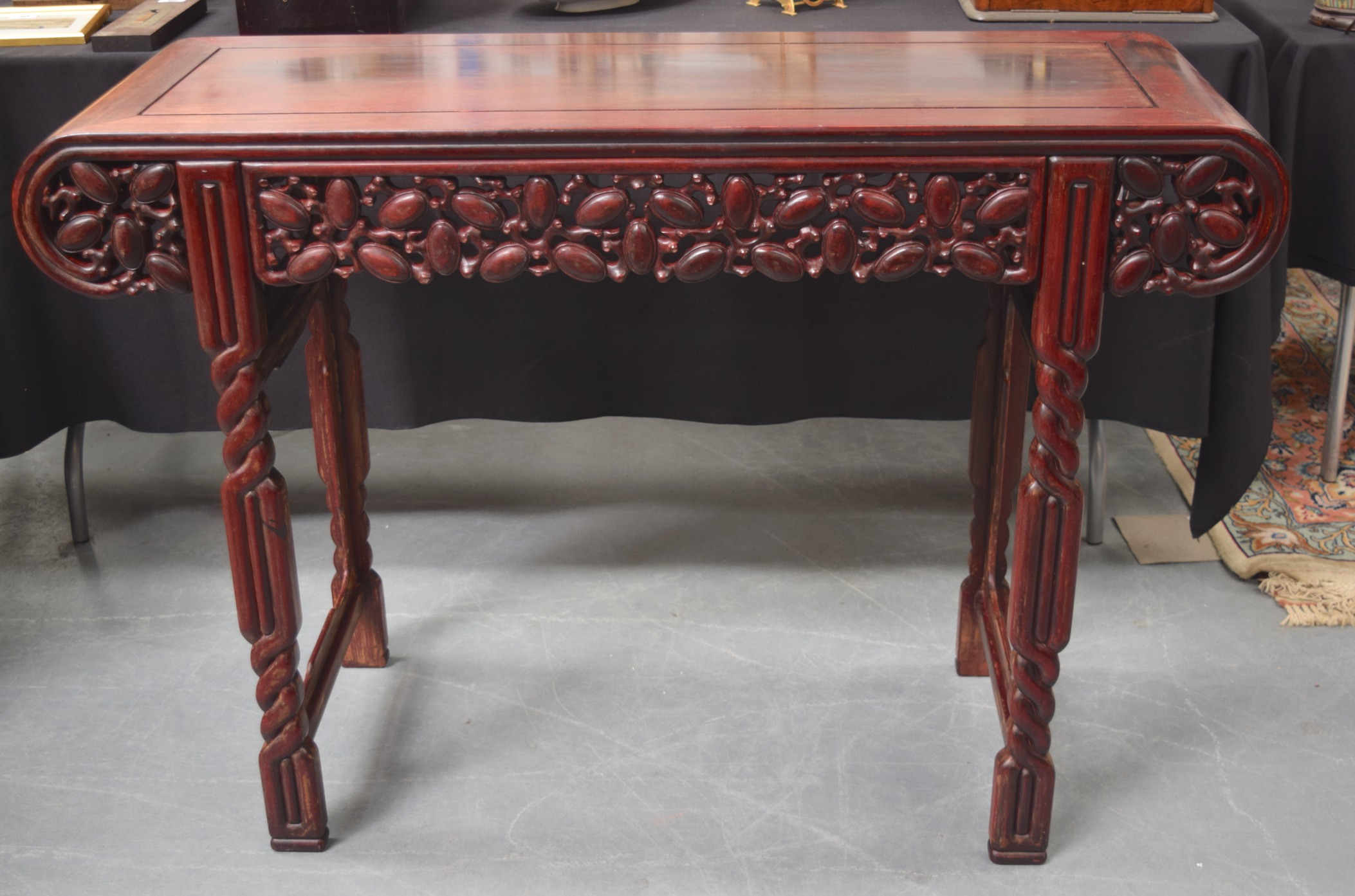 AN EARLY 20TH CENTURY CHINESE CARVED REDWOOD ALTAR TABLE with carved