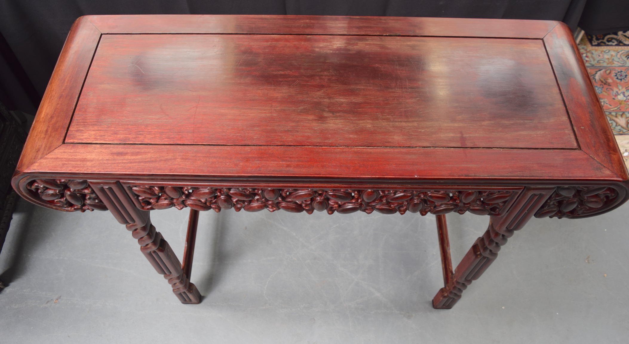 AN EARLY 20TH CENTURY CHINESE CARVED REDWOOD ALTAR TABLE with carved