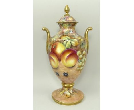 A G Delaney porcelain hand painted vase and cover of twin handled baluster form painted with fruit, signed, against a peach a