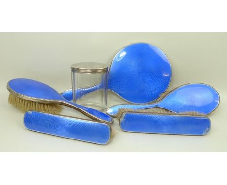 A five piece silver and engine turned blue guilloche enamel dressing table set, Birmingham 1927, comprising; hand mirror, pai