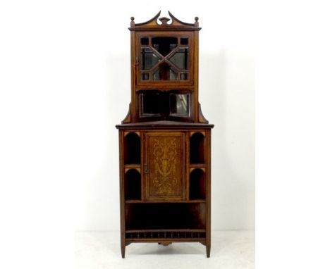 An Edwardian rosewood inlaid floor standing corner cabinet, the split pediment with inlaid fan decoration above an astragal g